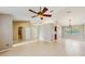 Bright open-concept living area features vaulted ceilings, tile floors, and a modern ceiling fan at 5130 Sun Palm Dr, Windermere, FL 34786