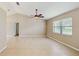 Bright living room with high ceilings, neutral paint, tan tile floors and a ceiling fan at 5130 Sun Palm Dr, Windermere, FL 34786