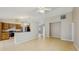 Open-concept living room and kitchen area featuring tile floors, island counter, and modern appliances at 5130 Sun Palm Dr, Windermere, FL 34786