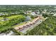 Aerial view of condos with lake and wooded area nearby at 563 Belltower Ave # 240, Deltona, FL 32725