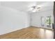 Clean bedroom with wood floors, a ceiling fan, and access to the outdoor patio at 563 Belltower Ave # 240, Deltona, FL 32725