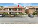 Condominium building featuring covered parking and well-maintained landscaping at 563 Belltower Ave # 240, Deltona, FL 32725