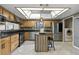 Kitchen with stainless appliances, wood cabinets, tile floors, and kitchen island at 563 Belltower Ave # 240, Deltona, FL 32725