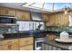 Spacious kitchen featuring stainless steel appliances, wood cabinets, and tile floors at 563 Belltower Ave # 240, Deltona, FL 32725