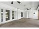 Enclosed lanai featuring multiple doors and ceiling fan at 563 Belltower Ave # 240, Deltona, FL 32725