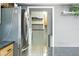 View of the laundry room adjacent to the kitchen, with built-in shelves for optimal storage solutions at 563 Belltower Ave # 240, Deltona, FL 32725