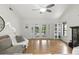 Bright living room with wood floors, a ceiling fan, and access to the outdoor patio at 563 Belltower Ave # 240, Deltona, FL 32725