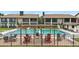 Community pool with seating, pergola and grilling area at 563 Belltower Ave # 240, Deltona, FL 32725