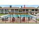 Community pool with lounge chairs and tables for residents at 563 Belltower Ave # 240, Deltona, FL 32725