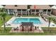 Community pool offers lounge chairs and covered seating in between condo buildings at 563 Belltower Ave # 240, Deltona, FL 32725