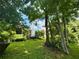 Lush backyard offers a serene escape with mature trees and an inviting patio at 660 Neile Ct, Oviedo, FL 32765