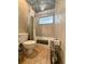 Bathroom with a bathtub, window, neutral tile, and decorative shower curtain at 660 Neile Ct, Oviedo, FL 32765