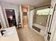 Well-lit bathroom with a tiled shower and tub combination and a view into the bedroom at 660 Neile Ct, Oviedo, FL 32765