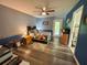 Cozy bedroom with hardwood floors, blue walls, a colorful quilt, and an ensuite bathroom at 660 Neile Ct, Oviedo, FL 32765