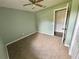 Empty bedroom with carpet, ceiling fan, light green walls, and a closet at 660 Neile Ct, Oviedo, FL 32765