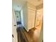 Hallway leading to bedrooms and bathrooms with wood flooring and white trim at 660 Neile Ct, Oviedo, FL 32765