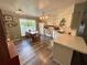 Bright kitchen featuring white cabinets, a peninsula, stainless steel appliances, and a dining area at 660 Neile Ct, Oviedo, FL 32765
