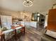 Bright kitchen with white cabinets and wood flooring that flows into an open living area at 660 Neile Ct, Oviedo, FL 32765