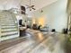 Spacious living room with hardwood floors, high ceilings, staircase, and comfortable seating area at 660 Neile Ct, Oviedo, FL 32765