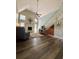 Bright and airy living room featuring high ceilings, a fireplace, wood flooring, and a staircase at 660 Neile Ct, Oviedo, FL 32765