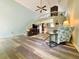 Open-concept living room with high ceilings, wood floors, and a view of the staircase and loft area at 660 Neile Ct, Oviedo, FL 32765