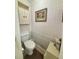 Cozy powder room with decorative wallpaper and a matching framed print at 660 Neile Ct, Oviedo, FL 32765