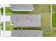 Aerial view of a well-maintained home showcasing the roof, fenced backyard, and surrounding landscape at 7112 Mottled Duck Dr, Harmony, FL 34773