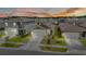 Scenic aerial shot of a residential neighborhood at sunset with manicured lawns at 7112 Mottled Duck Dr, Harmony, FL 34773