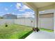 Well-maintained backyard with green grass, white fence, and small patio area, ideal for outdoor enjoyment at 7112 Mottled Duck Dr, Harmony, FL 34773