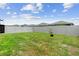 Spacious, fenced backyard with lush green grass and a small tree, perfect for recreation and privacy at 7112 Mottled Duck Dr, Harmony, FL 34773
