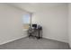 Bedroom with a window, carpeted floor, and a desk setup at 7112 Mottled Duck Dr, Harmony, FL 34773