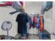 Organized walk-in closet with shelving, hanging rods, and neatly arranged clothing and accessories for storage at 7112 Mottled Duck Dr, Harmony, FL 34773