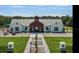 Community clubhouse features expansive parking, lush landscaping, and an elegant architectural design at 7112 Mottled Duck Dr, Harmony, FL 34773