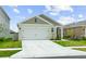 Lovely single-story home with a two-car garage and beautifully landscaped front yard at 7112 Mottled Duck Dr, Harmony, FL 34773