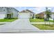 This is an eye-level view of the front of a single-Gathering home with an attached garage at 7112 Mottled Duck Dr, Harmony, FL 34773