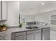 Open-concept kitchen with granite countertops, stainless steel dishwasher and view into the living area at 7112 Mottled Duck Dr, Harmony, FL 34773
