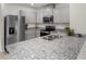 Modern kitchen with stainless steel appliances and granite countertops at 7112 Mottled Duck Dr, Harmony, FL 34773