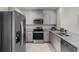 Well-equipped kitchen showcasing stainless steel appliances and sleek, light gray cabinetry at 7112 Mottled Duck Dr, Harmony, FL 34773
