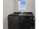 Laundry room with new Samsung washer and dryer set with bright window at 7112 Mottled Duck Dr, Harmony, FL 34773