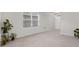Bright living room with tile flooring, large window, and plants at 7112 Mottled Duck Dr, Harmony, FL 34773