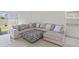 Comfortable living room with a large sectional sofa and natural light from a window and sliding door at 7112 Mottled Duck Dr, Harmony, FL 34773
