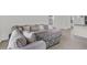 Spacious living room with a comfortable sectional sofa, view of the kitchen and neutral color palette at 7112 Mottled Duck Dr, Harmony, FL 34773