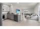 Open living space with kitchen, dining, and living area with large sectional couch at 7112 Mottled Duck Dr, Harmony, FL 34773