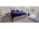 Cozy bedroom with a rustic-style bed frame, bedside tables, and natural light from the window at 7112 Mottled Duck Dr, Harmony, FL 34773