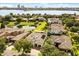 An aerial view captures the community setting, lush landscaping, and waterfront views at 7733 Pointe Venezia Dr, Orlando, FL 32836