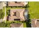 Aerial view showcases the tile roof and screened-in pool at 7733 Pointe Venezia Dr, Orlando, FL 32836