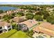This aerial view showcases the home's tile roof and screened-in pool in the neighborhood at 7733 Pointe Venezia Dr, Orlando, FL 32836