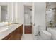 A marble tiled bathroom featuring stylish fixtures, a modern toilet, and a tub/shower combo at 7733 Pointe Venezia Dr, Orlando, FL 32836