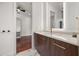 Bright bathroom with marble floors, floating vanity, and stylish fixtures, leading to a walk-in closet at 7733 Pointe Venezia Dr, Orlando, FL 32836