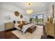 Bedroom featuring luxury chandelier, wood floors, bench and stylish decor at 7733 Pointe Venezia Dr, Orlando, FL 32836